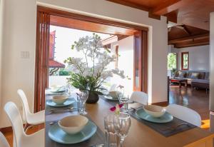 a dining room with a table with chairs and a dining room at Oriental Thai Villa in Koh Samui 