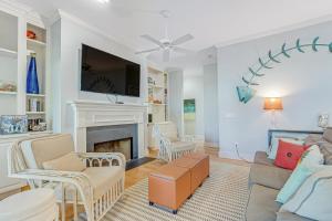 a living room with a couch and a fireplace at Tradewinds in Folly Beach