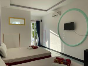 a bedroom with two beds and a mirror at Windy hills hotel in Mui Ne