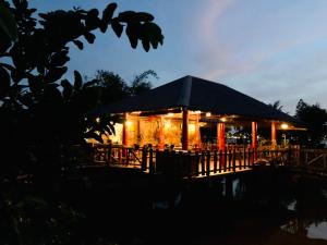 a building with lights on it at night at mekong riverside homestay in Vĩnh Long