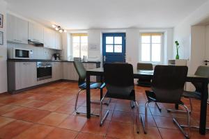 a kitchen with a table and chairs in a room at Flat in Klocksin with a garden in Klocksin