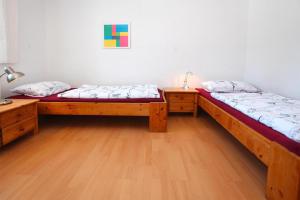 two beds in a room with wooden floors at Flat in Klocksin with a garden in Klocksin
