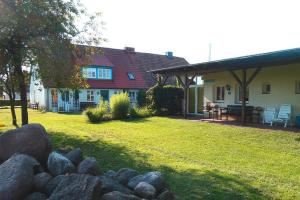 a house with a yard with rocks in front of it at Flat in Klocksin with a garden in Klocksin