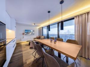 a dining room with a long table and chairs at Apartments B-HOME, Bramberg am Wildkogel in Bramberg am Wildkogel