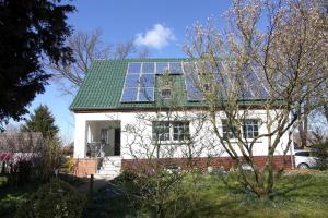 a house with solar panels on the roof at Apartment, Mallentin in Mallentin