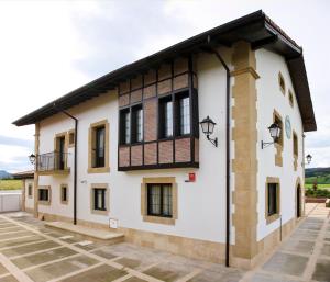 a large white building with a black roof at Posada Casona de la Ventilla in Laredo