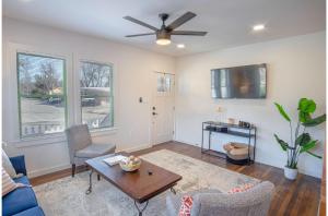 a living room with a ceiling fan and a table at Dazzling 3 BR2 BA Home Near Downtown Tower Americas in San Antonio