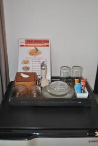 a tray with plates and dishes on top of a stove at Baan Kata Maytha in Kata Beach