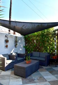 a patio with blue couches and tables at 50 ON GREEFF in Lichtenburg