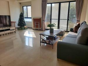 a living room with a christmas tree and a couch at 河畔暮光-台南安平包棟民宿villa in Anping