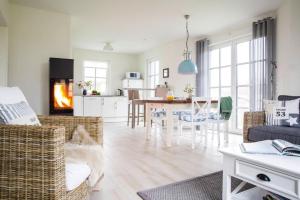 a living room with a couch and a dining room at Holiday house, Fuhlendorf in Fuhlendorf