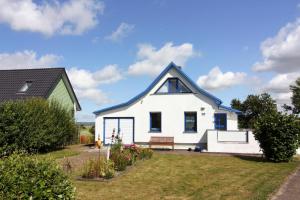 a white house with a blue roof at Holiday House, Barth in Barth