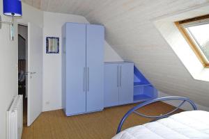 a bedroom with a blue cabinet in a attic at Holiday home, Pléneuf-Val-André in Pléneuf-Val-André
