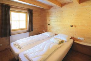 a room with two beds in a wooden cabin at Chalet, Königsleiten in Königsleiten