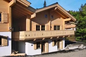 a house with a balcony on the side of it at Chalet, Königsleiten in Königsleiten