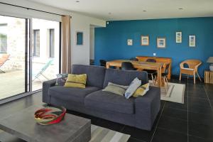 a living room with a couch and a table at Holiday Home in Plougasnou near Sandy Beach in Plougasnou