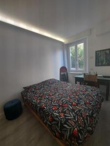 a bedroom with a bed and a desk and a window at Domotica Ancona in Ancona