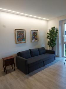 a living room with a blue couch and a table at Domotica Ancona in Ancona +31 photos