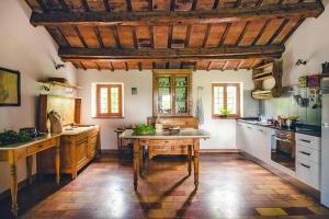 a large kitchen with wooden ceilings and a wooden table at Country House in Monterado with Pool in Monterado