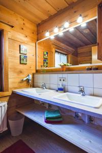 a bathroom with two sinks and a large mirror at Chalets in Eben im Pongau in Eben im Pongau