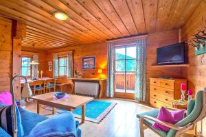 a living room with a table and a television in a cabin at Chalets in Eben im Pongau in Eben im Pongau