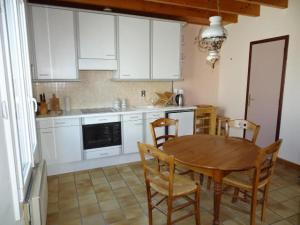 a kitchen with a wooden table and chairs in a kitchen at Apartment, Quimper in Quimper