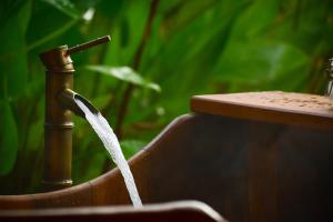 a water hose coming out of a water fountain at Onsen at Moncham in Mae Rim