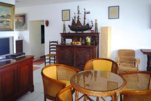 a living room with a glass table and chairs at Holiday Home Trebeurden by Pink Granite Coast in Trébeurden
