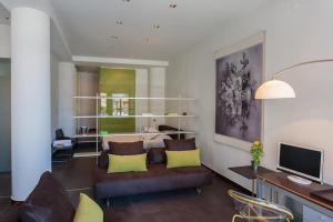 a living room with a couch and a television at Faro Apartments in Chania