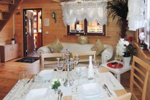 a dining room with a white table and chairs at Holiday homes, Rewal in Rewal