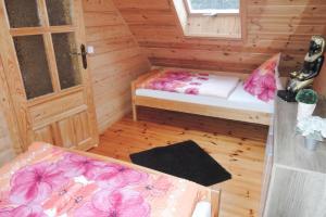 a small room with two beds and a door at Holiday homes, Rewal in Rewal