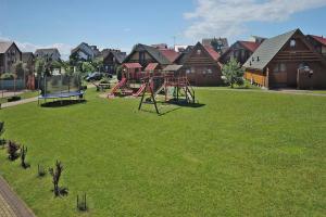 a park with a playground in a yard with houses at Holiday resort, Rewal in Rewal