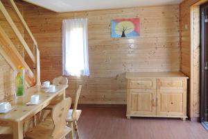 a wooden room with a table and chairs and a window at Holiday resort, Rewal in Rewal