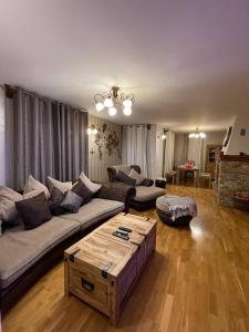 a living room with a couch and a coffee table at Remarkable home Bohinj Lake in Bohinj