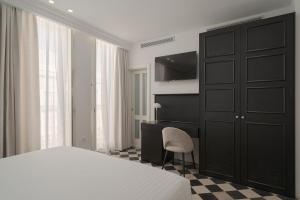 A bed or beds in a room at Boutique Hotel Cordial La Niña de Vegueta