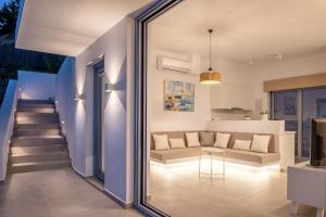 a living room with a couch and a table at Zante Fiore Suites in Xirokástellon