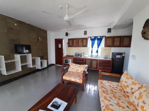 a living room with a couch and a table at Aqua Resort in Diani Beach