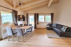 a living room with a table and a couch at Apartment in Milders with Stubai SuperCard in Neustift im Stubaital