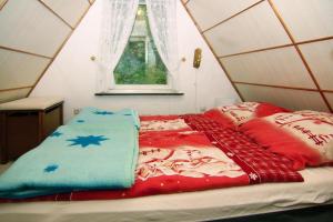 a bed in a dome tent with blankets and pillows at holiday home, Perlin in Perlin