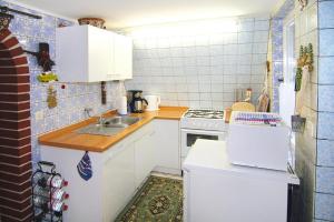 a small kitchen with a sink and a stove at holiday home, Perlin in Perlin