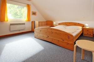 a bedroom with a wooden bed and a window at Holiday resort in the M ritz National Park Mirow in Mirow
