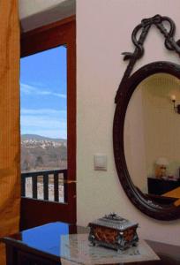 a mirror on a wall in a room with a table at Diaselon in Elatochori