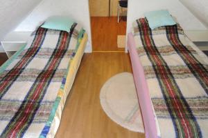 two twin beds in a room with a wooden floor at holiday home, Kolczewo in Kołczewo