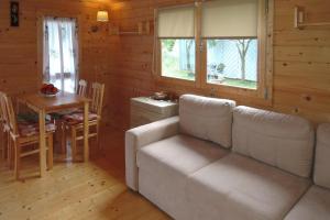 a living room with a couch and a table at Bungalow, Wrzosowo in Wrzosowo