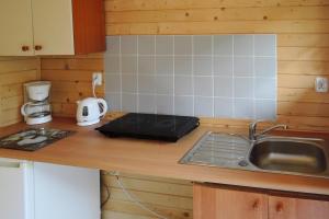 a kitchen with a sink and a counter top at Bungalow, Wrzosowo in Wrzosowo
