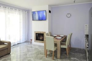 a dining room with a table and a fireplace at Holiday flat, Lukecin in Łukęcin