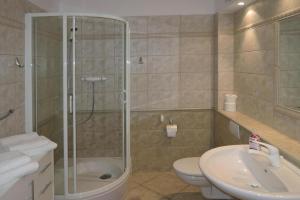 a bathroom with a shower and a toilet and a sink at Holiday flat, Miedzyzdroje in Międzyzdroje