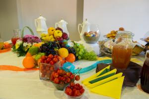 a table with fruits and vegetables in bowls on it at Hotel Dei Pini in Porto Empedocle