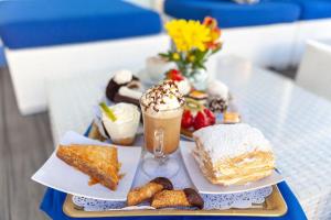 a tray of desserts and drinks on a table at Dev Bhoomi Resort in Kanatal