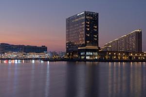 a view of a city with tall buildings and the water at Hyatt Centric Lakeside Ningbo in Ningbo
